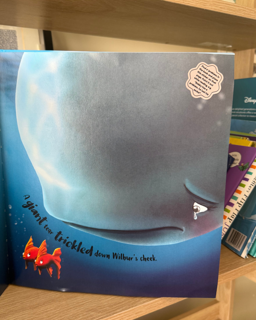 Children's story book with a BookBuddies repositionable shared book reading sticker prompt.