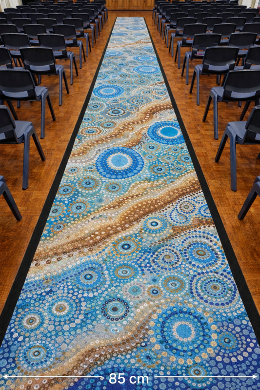 school hall runner with indigenous design on a wooden floor in a room with chairs.