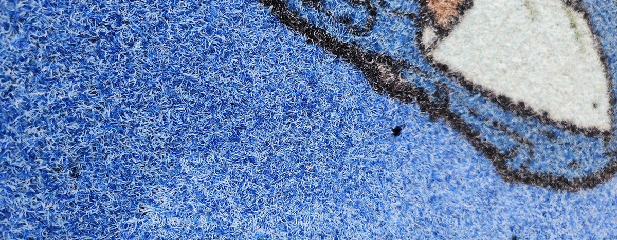 close up of outdoor mat with drainage holes 