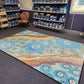River Country classroom rug, 2m x 3m, amazing blues and natural tones. Indigenous art, durable with non-slip and non-trip design. Shown in school library.
